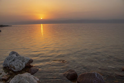 Sunset at the lowest point in the earth in the dead sea , where located in south of jordan