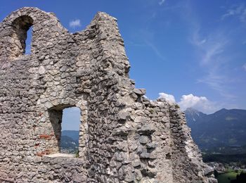 Low angle view of stone wall against sky