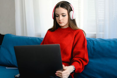 Young woman using laptop at home