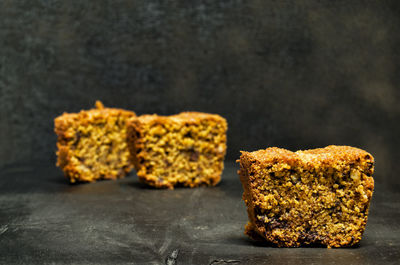 Close-up of bread on table against black background