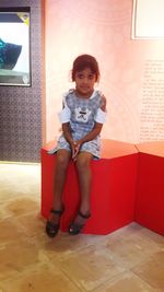 Portrait of cute girl standing on floor at home