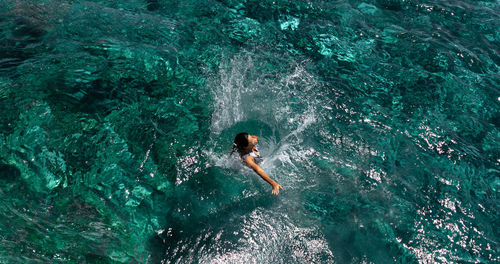 High angle view of man swimming in sea