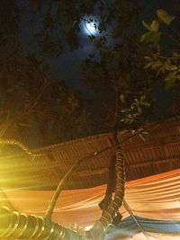 Panoramic view of illuminated field against sky at night