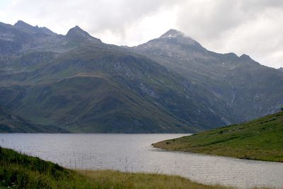 Scenic view of lake and mountains against sky