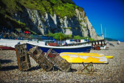 Boats moored at beach against sky