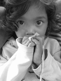 Close-up portrait of cute girl eating food