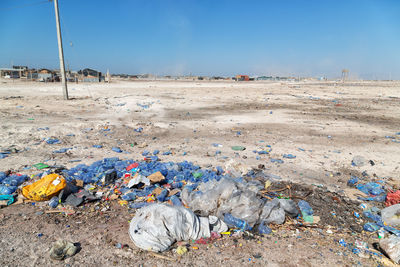 Garbage on sand at beach against sky