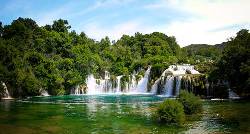 Scenic view of waterfall against sky