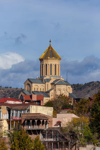 Temple building against cloudy sky