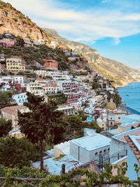 High angle view of townscape by sea against sky