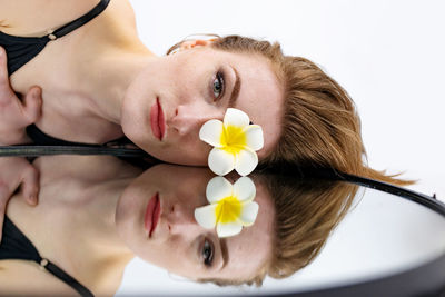 High angle view of woman holding flower