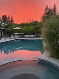 Scenic view of swimming pool against sky during sunset