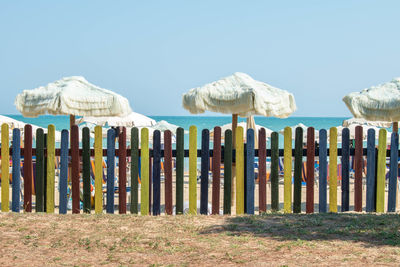 Panoramic shot of wooden post on sea against clear sky
