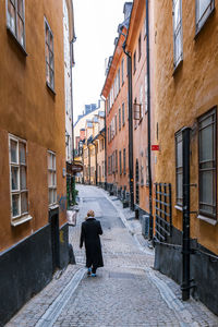 Man in city against sky