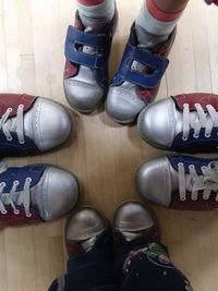 Low section of man standing on multi colored shoes