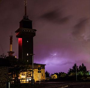 Low angle view of illuminated tower at night