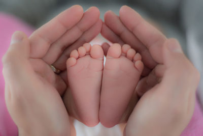 Low section of man with baby feet