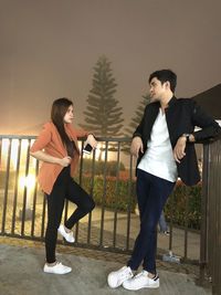 Full length of young couple standing outdoors