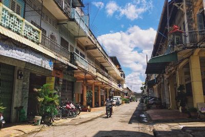 Street amidst buildings in city against sky