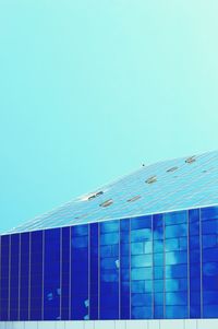 Low angle view of building against clear blue sky