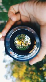 Close-up of cropped hand holding camera