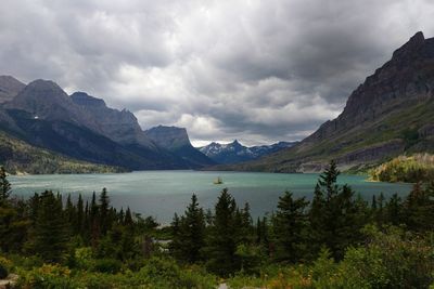 Scenic view of lake and mountains against sky