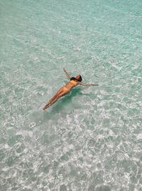 High angle view of woman swimming in sea