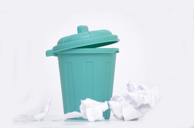 Garbage bin against white background