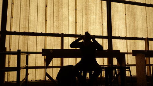 Silhouette woman sitting on chair