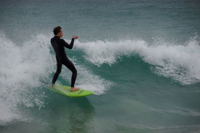 Side view of man surfing in sea