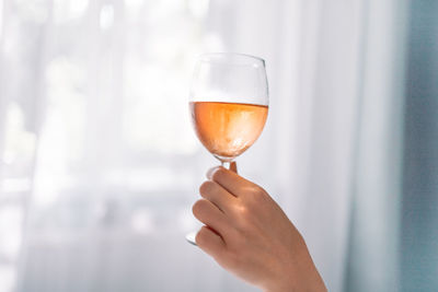 Close-up of hand holding glass of drink