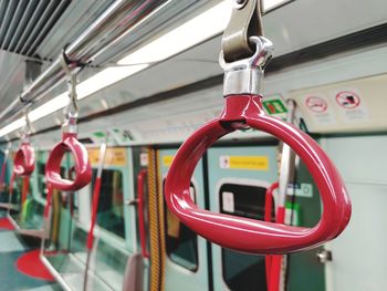 Close-up of red handles in train