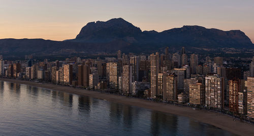 Panoramic view of city against sky at sunset