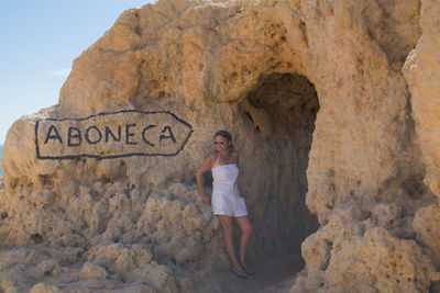 Full length of woman standing on rock