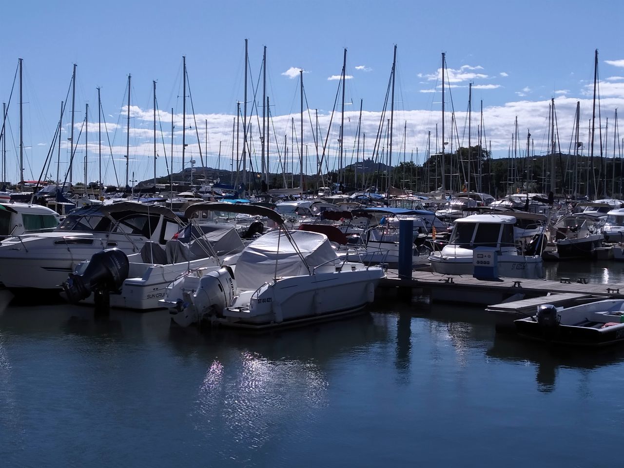 marina, water, nautical vessel, dock, transportation, mode of transportation, sailboat, moored, harbor, sky, pole, mast, sea, reflection, no people, nature, boat, ship, vehicle, port, day, tranquility, outdoors, yacht, travel, clear sky, watercraft, travel destinations, blue, architecture, pier, beauty in nature, bay