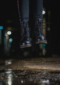 Low section of person in illuminated water at night