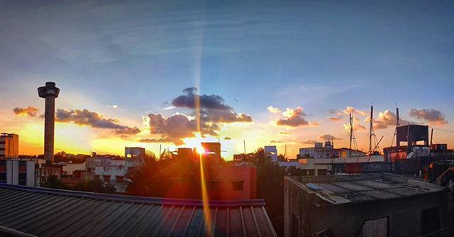 building exterior, architecture, built structure, sunset, sky, sun, sunlight, sunbeam, house, street light, residential building, city, residential structure, lens flare, cloud - sky, orange color, outdoors, building, blue, residential district