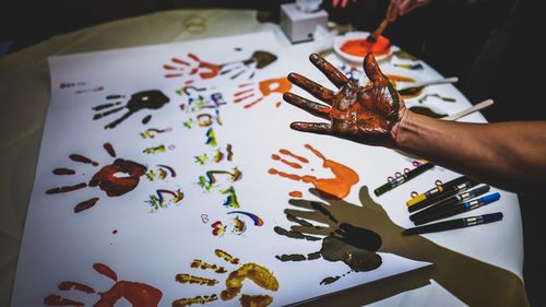 Cropped image of person with colored hand