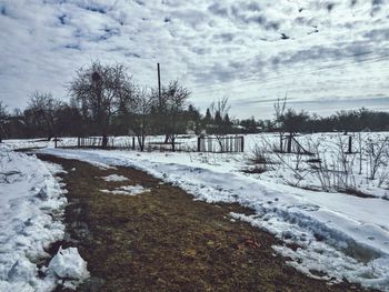 Snow covered field against sky