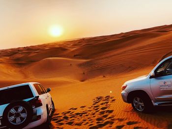 Vintage car on desert against clear sky