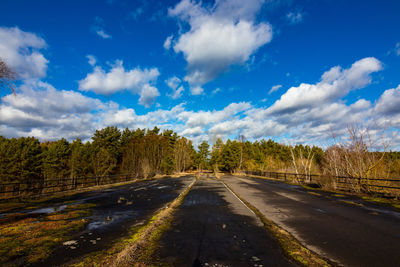 Road amidst trees against sky