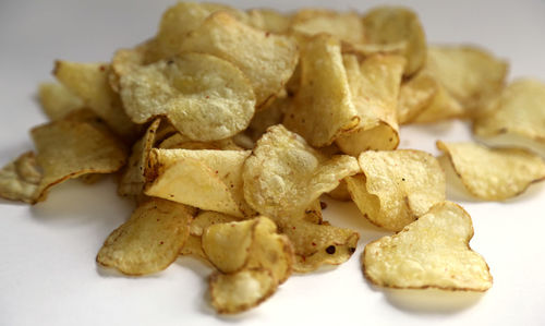 Close-up of crisps against white background 