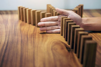 Cropped image of person with toy block on table