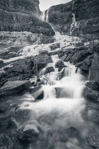 Black and white vertical long shutter shot of cascading waterfall from canadian rockies, canada