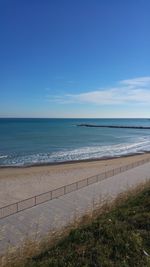 Scenic view of sea against clear blue sky