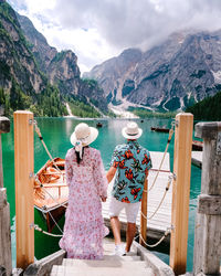 Rear view of woman looking at sea against mountains