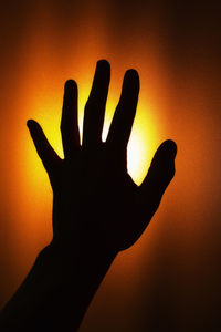 Close-up of silhouette hand during sunset