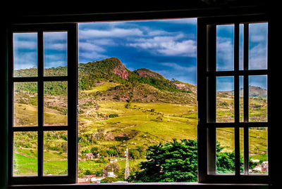 Scenic view of mountains seen through window