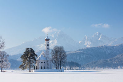 Scenic view of snowcapped mountains against blue sky