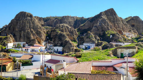 Panoramic view of buildings and mountains against clear sky